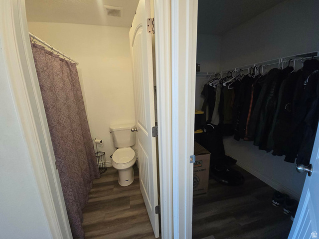 90 East Resaca Drive, Unit C11 Sandy, UT 84070 - Photo 8 of 27 Master bathroom with a shower with shower curtain, a spacious closet, and dark wood-type flooring