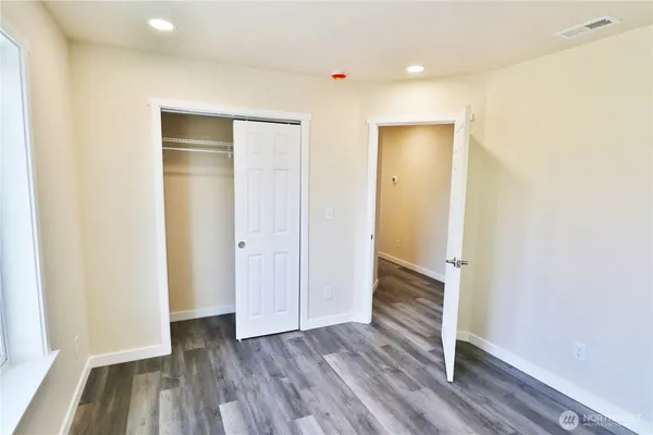 a spacious bathroom with a double vanity sink and a mirror