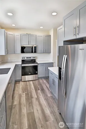 a kitchen with stainless steel appliances a refrigerator sink and cabinets