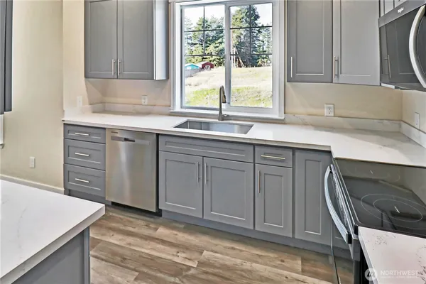 a kitchen with a sink stove and cabinets