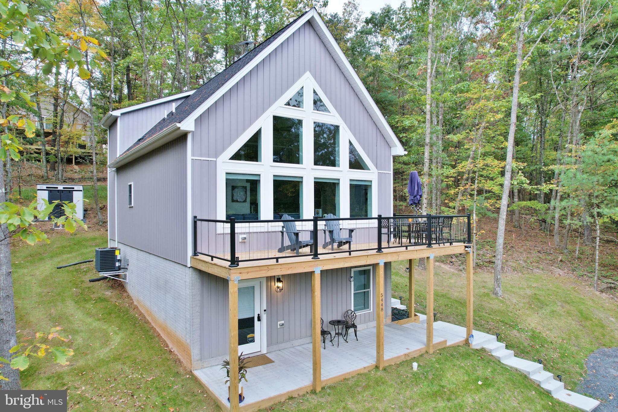 a backyard of a house with yard and outdoor seating