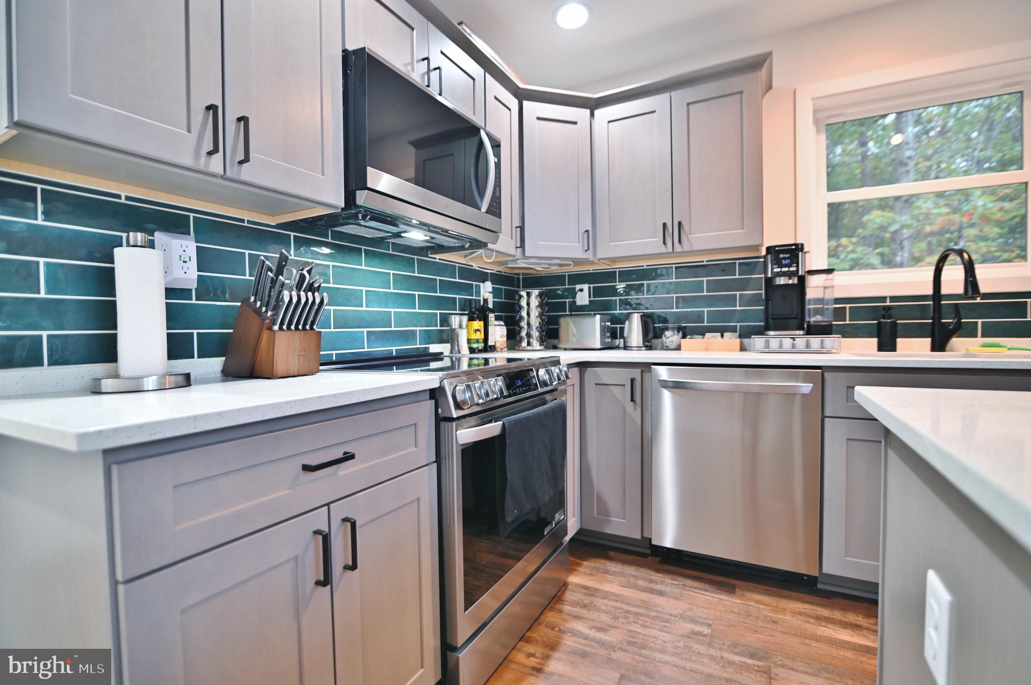 5448 Crooked Run Road Mount Jackson, VA 22842 - Photo 14 of 67 a kitchen with stainless steel appliances granite countertop a sink a stove a microwave and cabinets