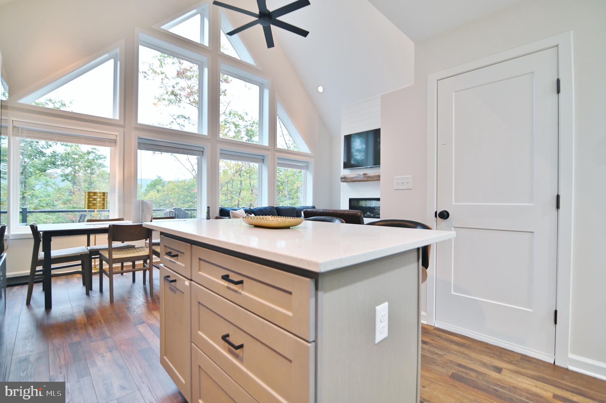 5448 Crooked Run Road Mount Jackson, VA 22842 - Photo 16 of 67 a kitchen with a table chairs stove and wooden floor
