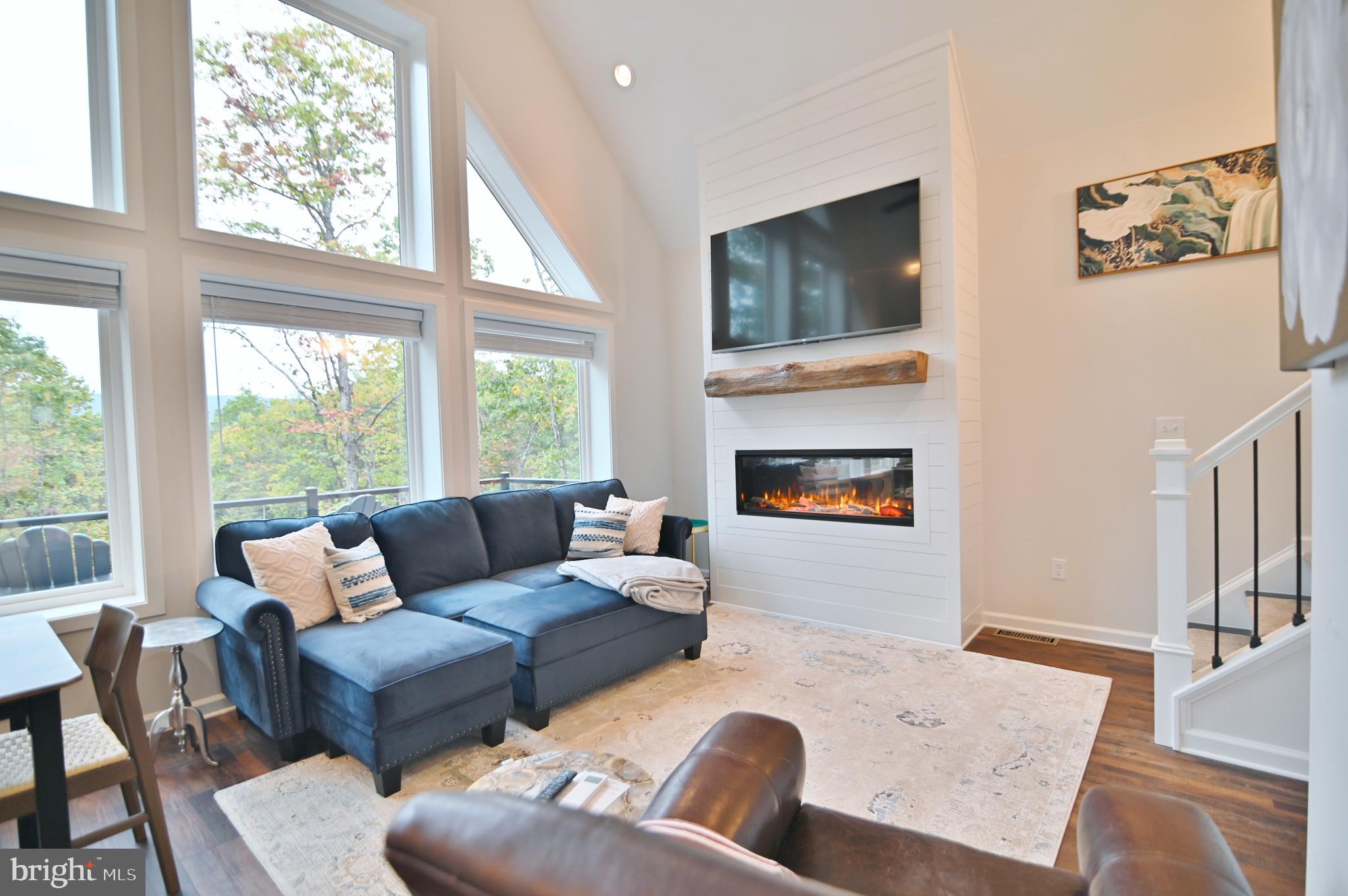 5448 Crooked Run Road Mount Jackson, VA 22842 - Photo 18 of 67 a living room with furniture large window and a fireplace