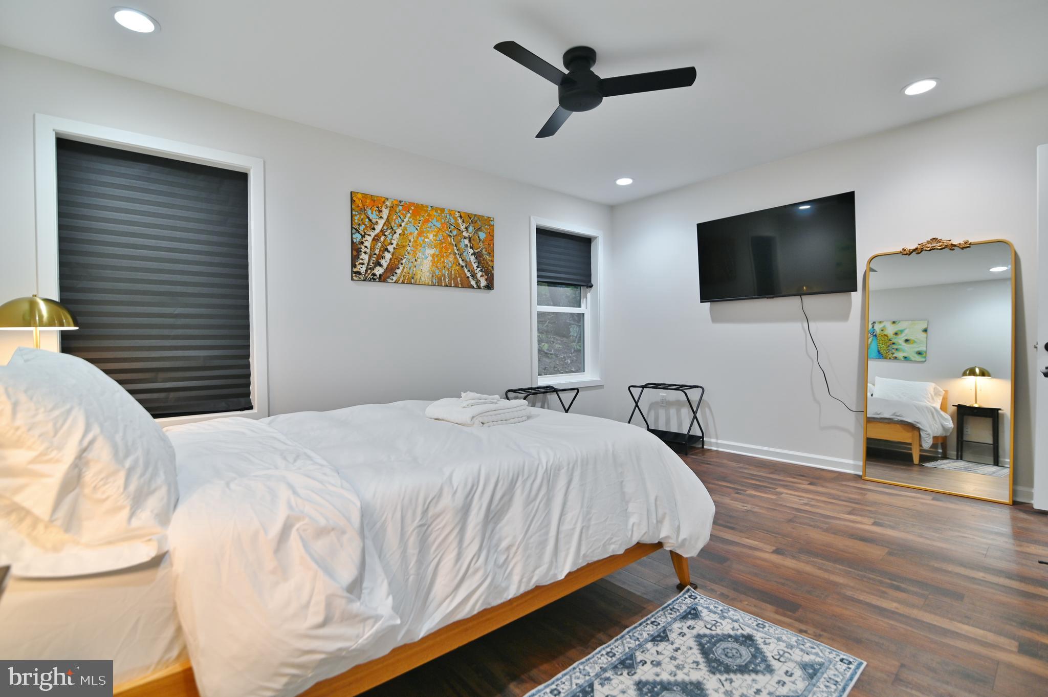 5448 Crooked Run Road Mount Jackson, VA 22842 - Photo 23 of 67 a bedroom with a bed a flat screen tv and a couch