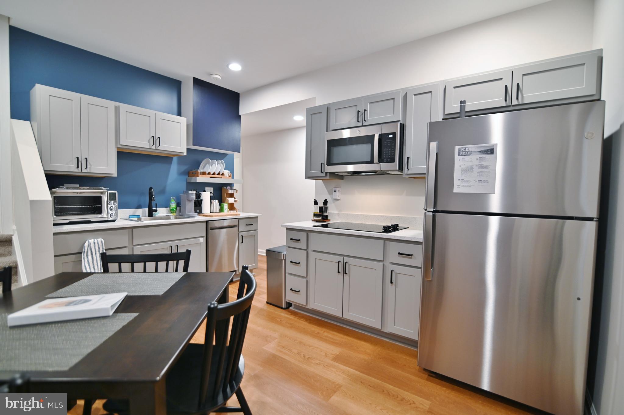 5448 Crooked Run Road Mount Jackson, VA 22842 - Photo 44 of 67 a kitchen with stainless steel appliances granite countertop a refrigerator a stove a sink a dining table and chairs
