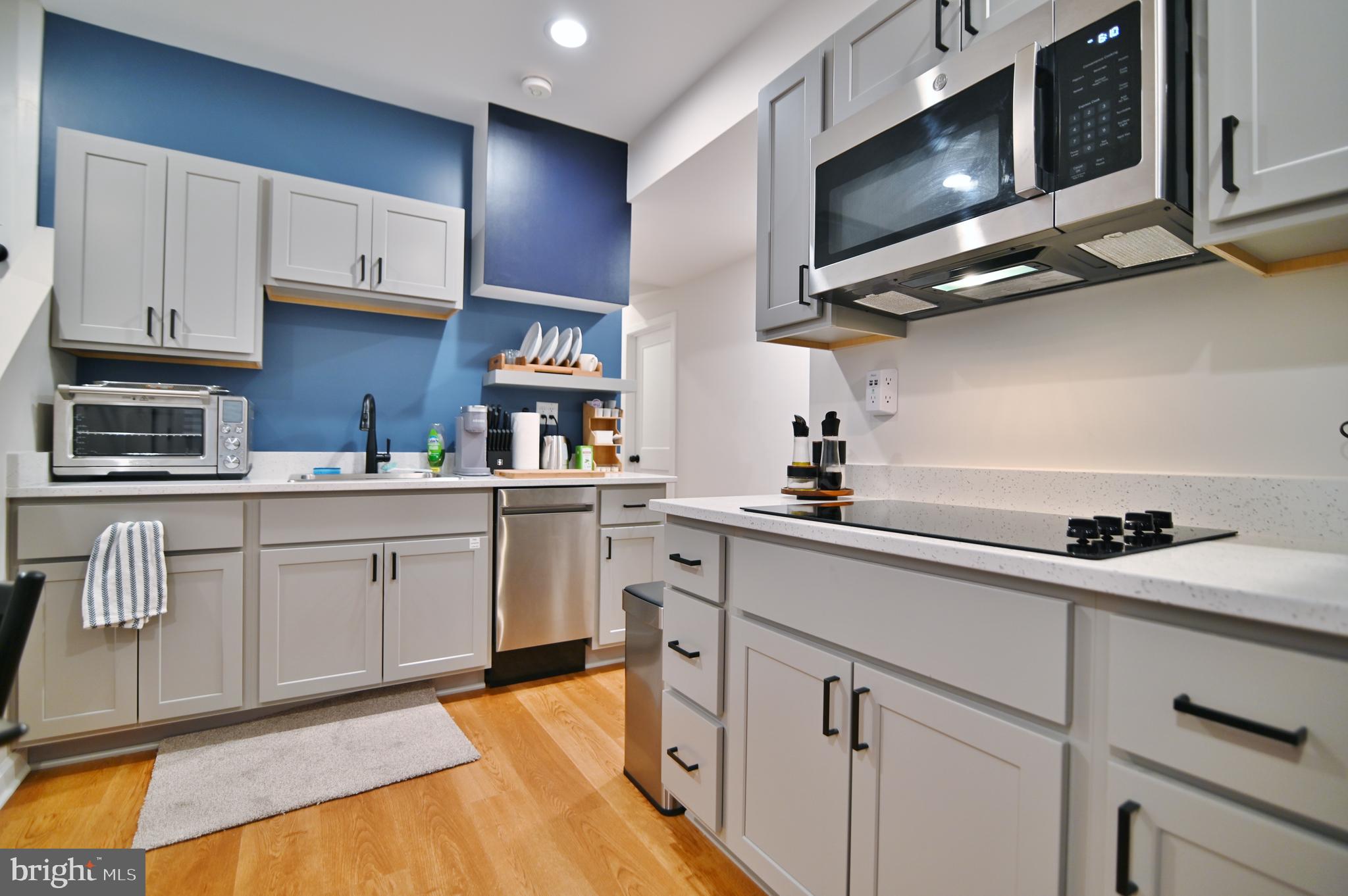 5448 Crooked Run Road Mount Jackson, VA 22842 - Photo 45 of 67 a kitchen with stainless steel appliances white cabinets sink and a microwave