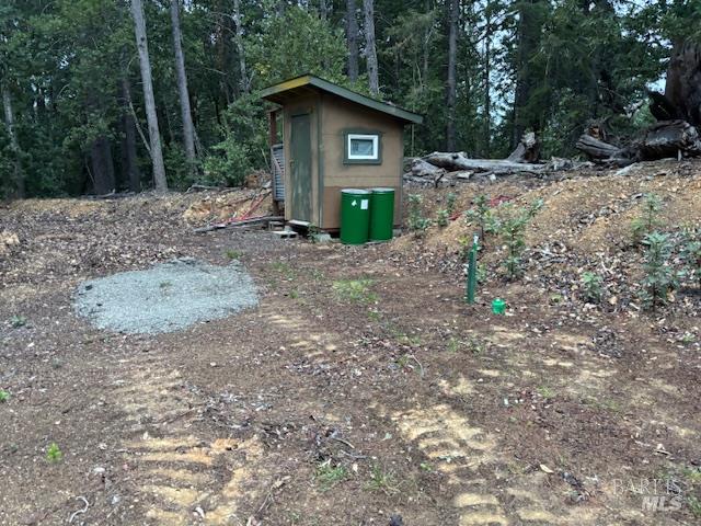 17707 Rockpile Road Geyserville, CA 95441 - Photo 6 of 22 a view of a wooden house with large trees