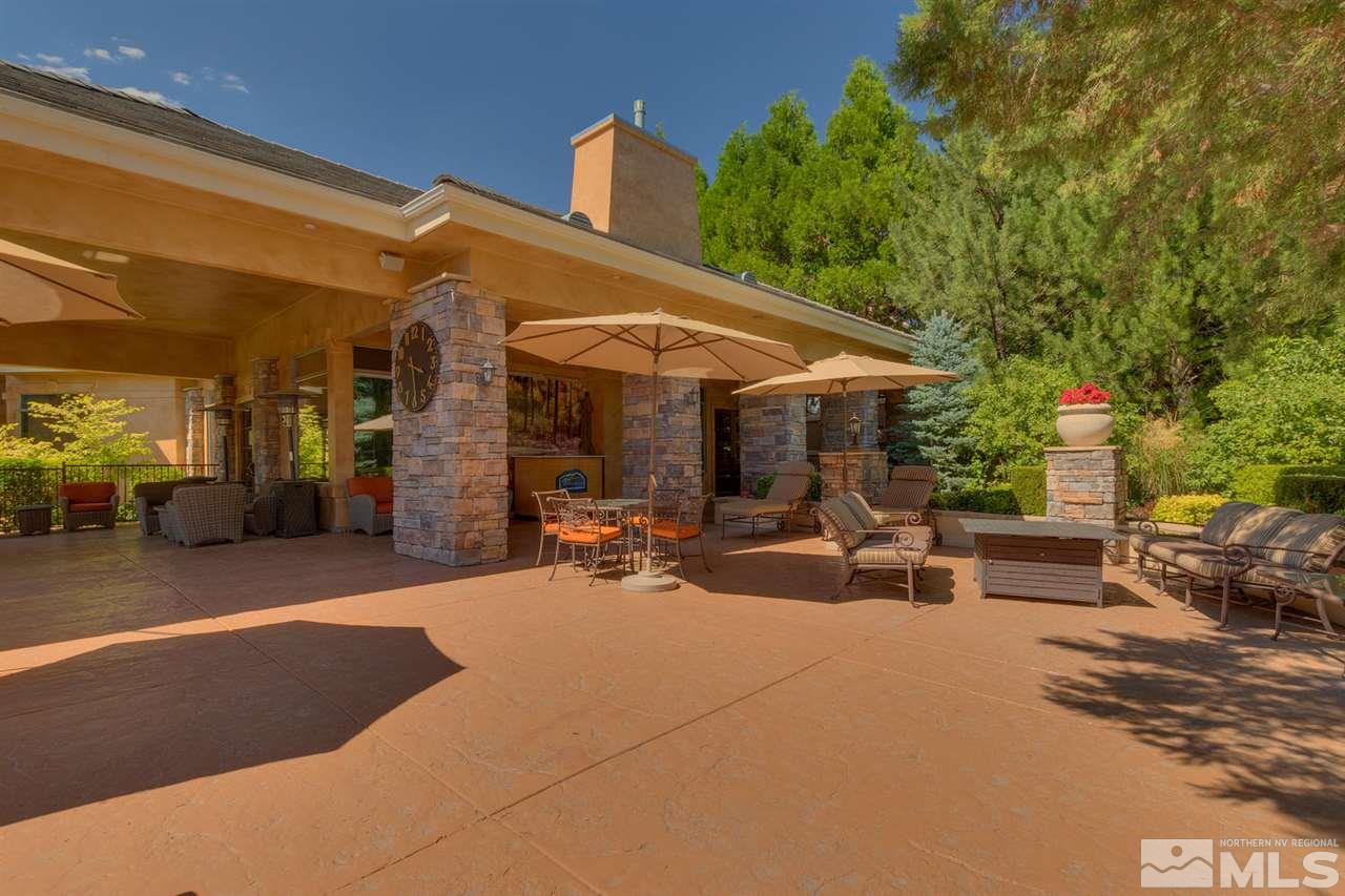 900 South, Unit 3413 Reno, NV 89521 - Photo 5 of 21 a view of a patio with table and chairs under an umbrella with a barbeque
