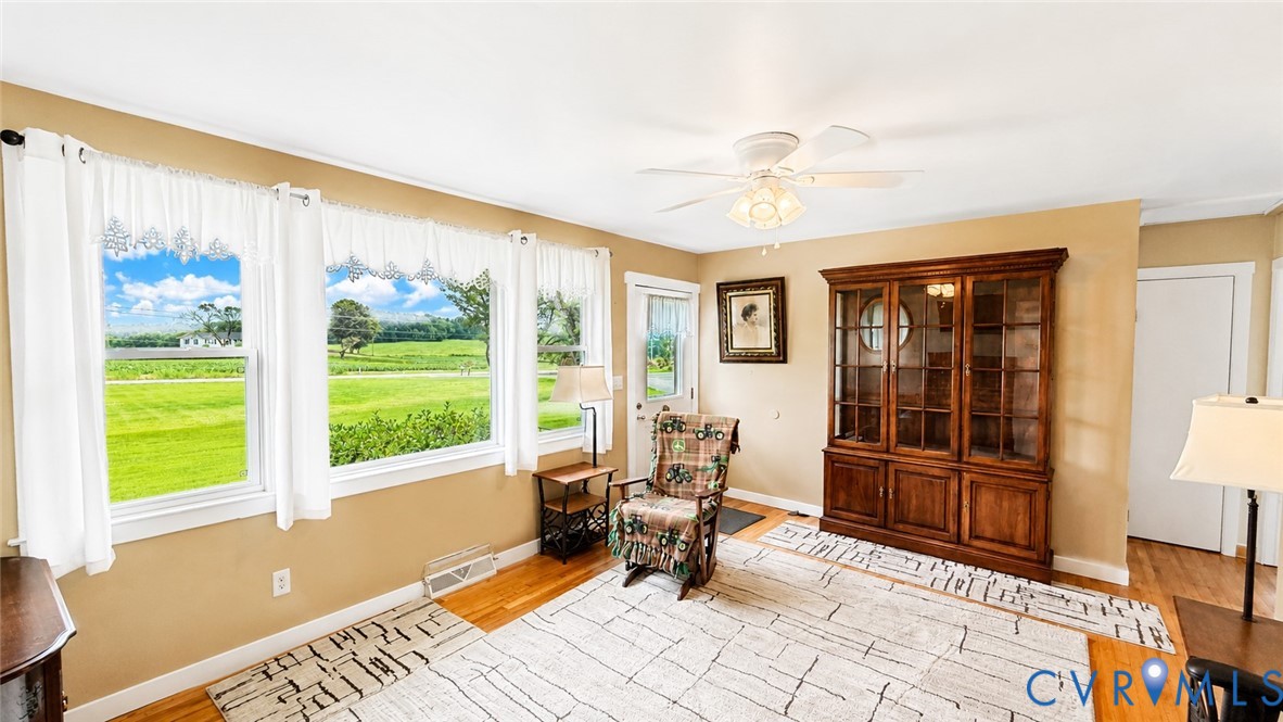5560 West Hoover Road Reva, VA 22735 - Photo 17 of 32 Living area featuring three large windows, hardwoo