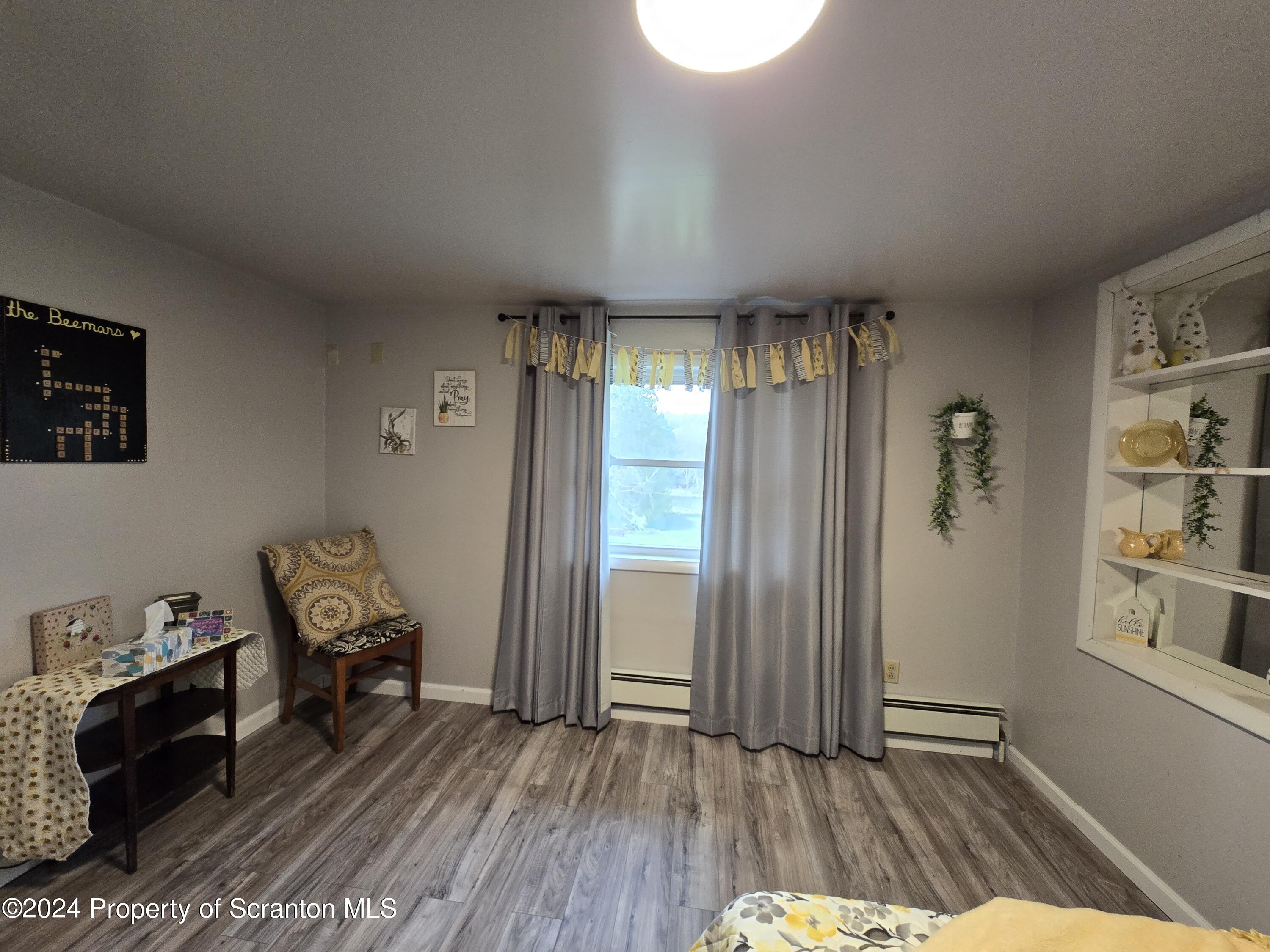 6736 Kingsley Road Kingsley, PA 18826 - Photo 14 of 42 a view of a hallway with wooden floor and furniture