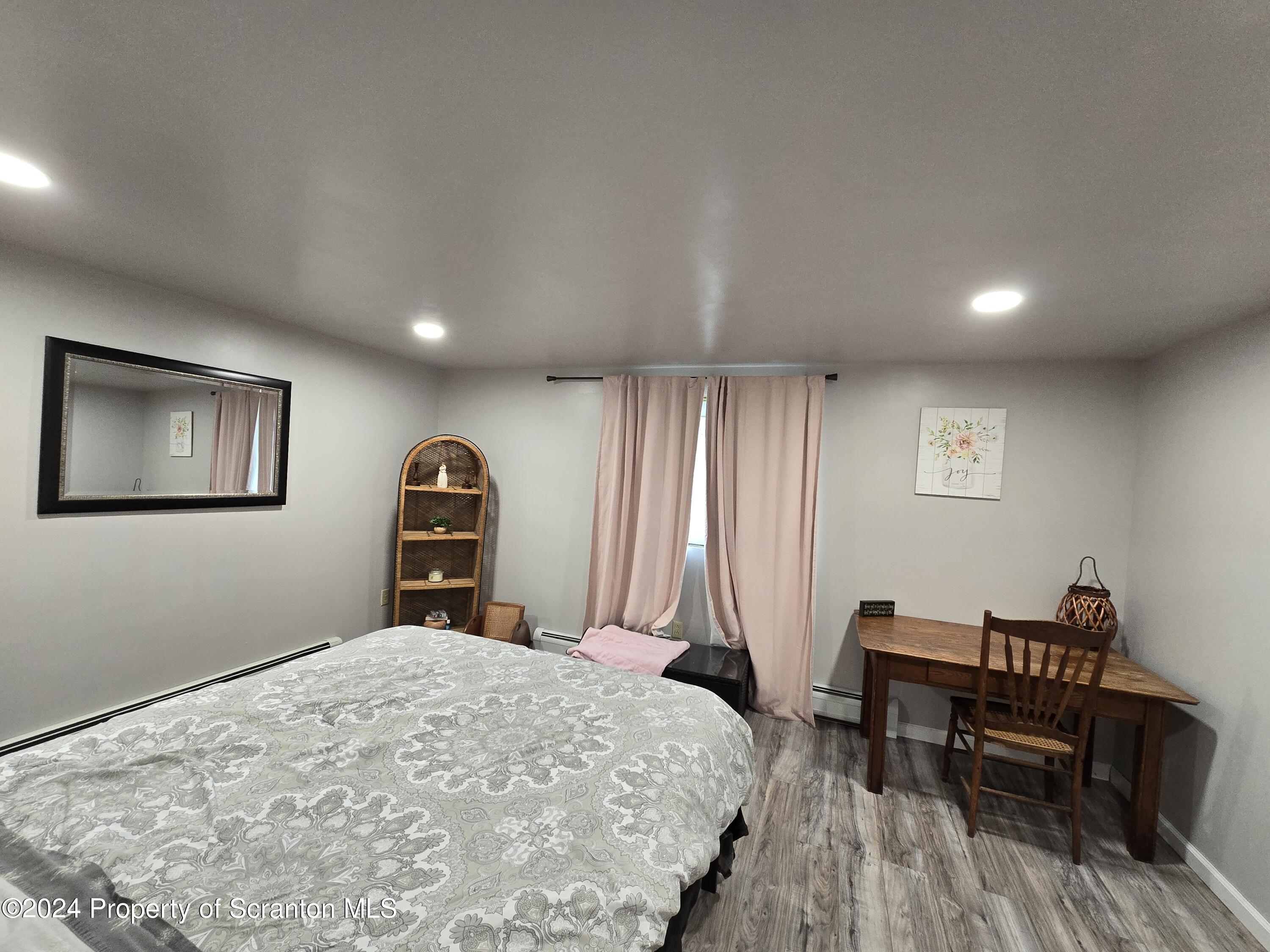 6736 Kingsley Road Kingsley, PA 18826 - Photo 15 of 42 a bedroom with a bed and a table in it