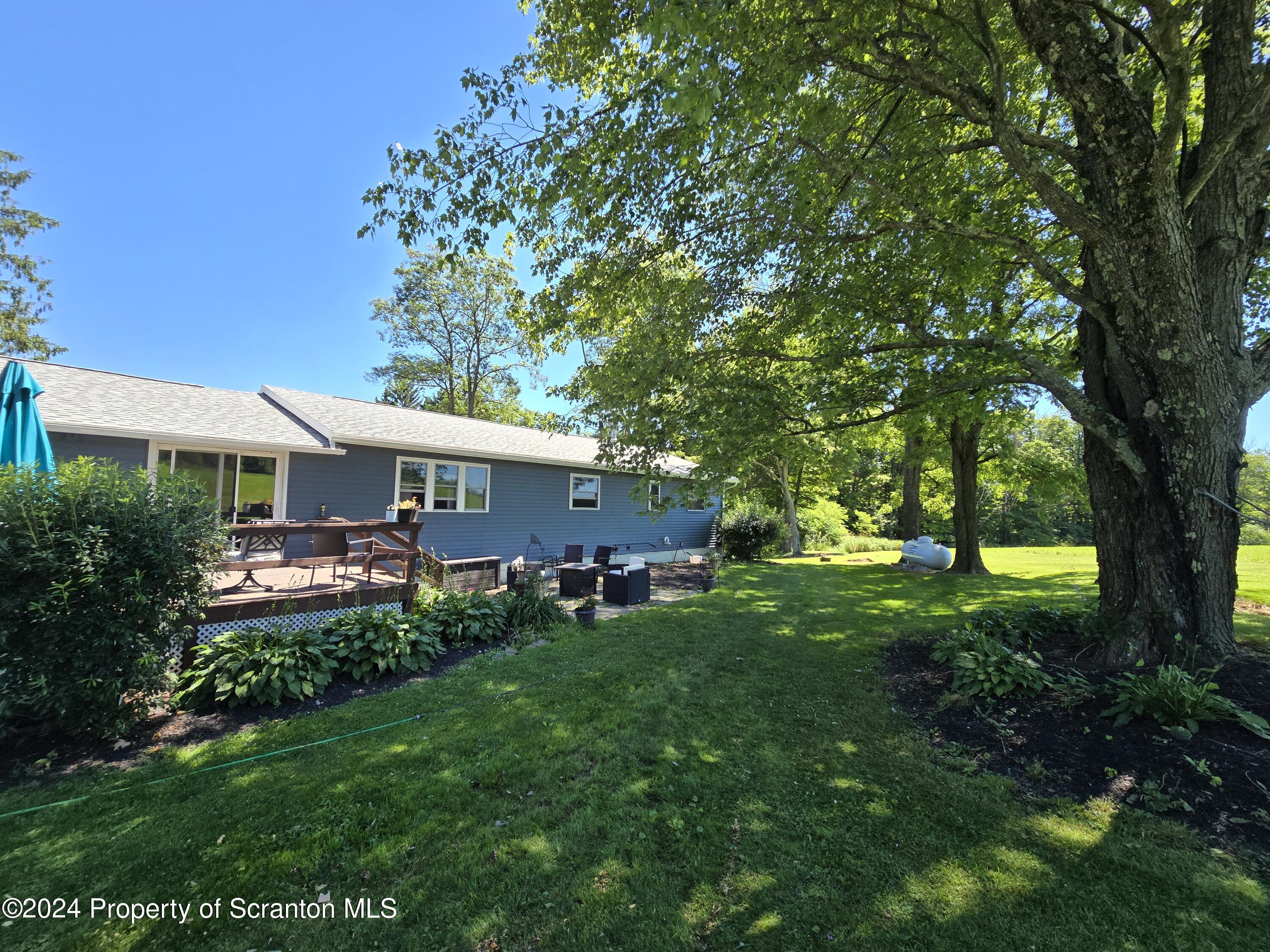 6736 Kingsley Road Kingsley, PA 18826 - Photo 2 of 42 a front view of a house with garden