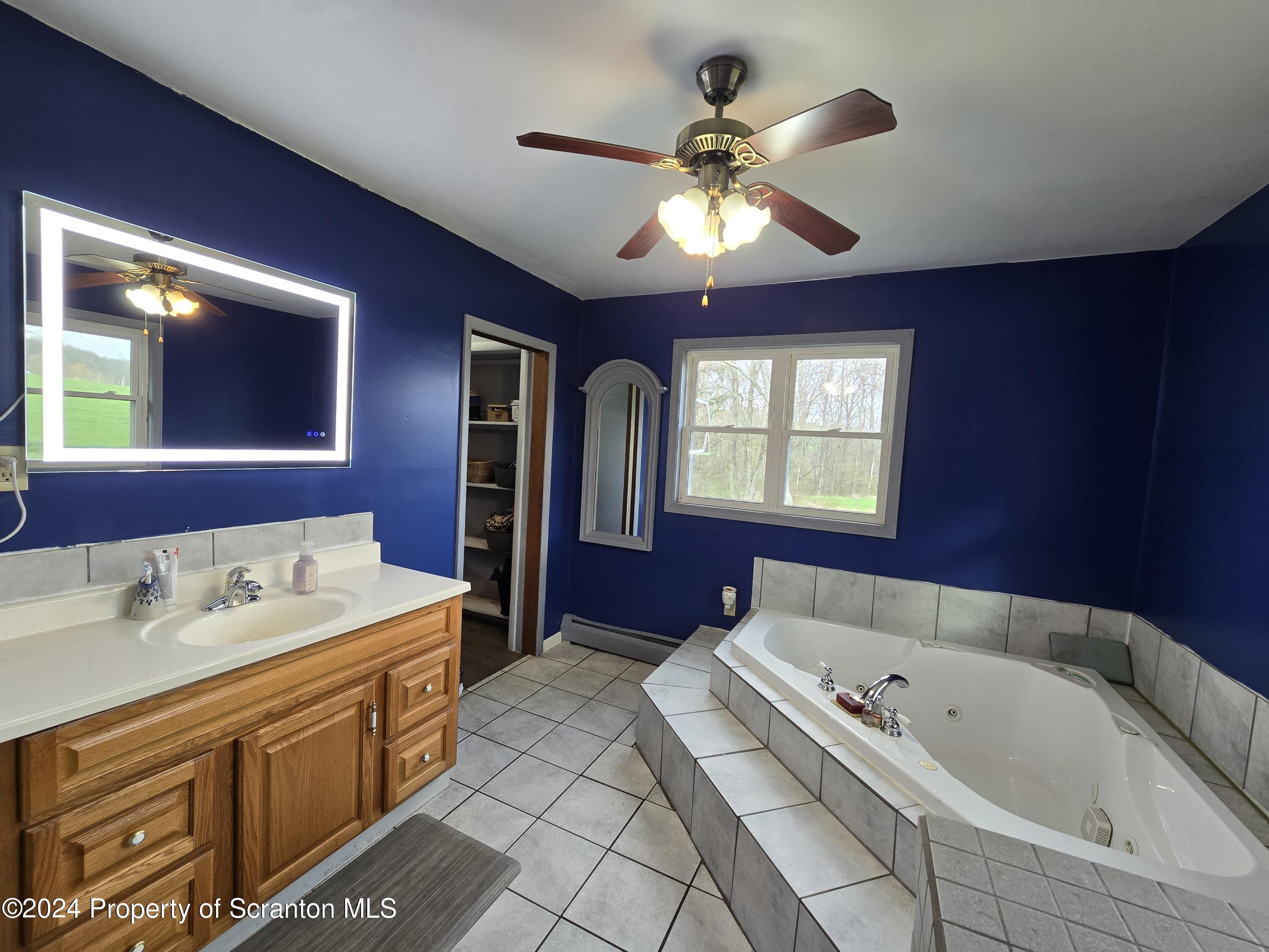 6736 Kingsley Road Kingsley, PA 18826 - Photo 23 of 42 a spacious bathroom with a tub sink and mirror