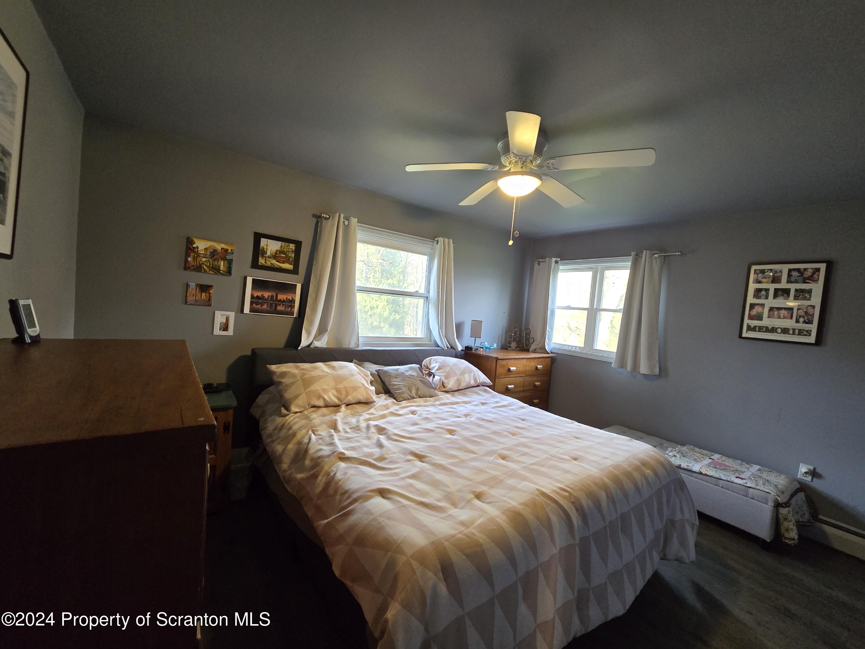 6736 Kingsley Road Kingsley, PA 18826 - Photo 26 of 42 a bed sitting in a bedroom next to a window