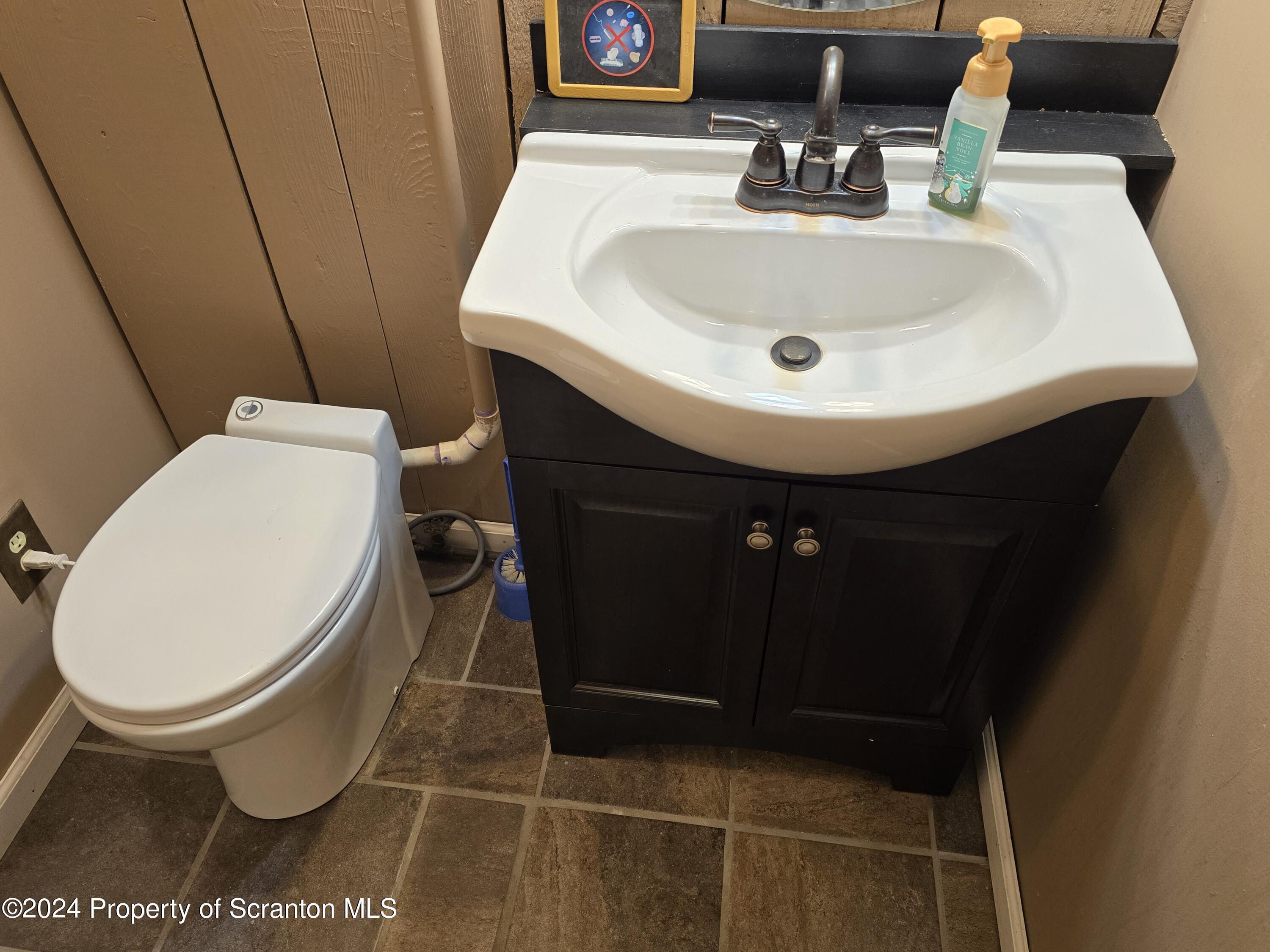 6736 Kingsley Road Kingsley, PA 18826 - Photo 29 of 42 a bathroom with a sink and a mirror