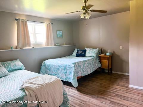 6736 Kingsley Road Kingsley, PA 18826 - Photo 36 of 42 a bedroom with two beds and a chandelier