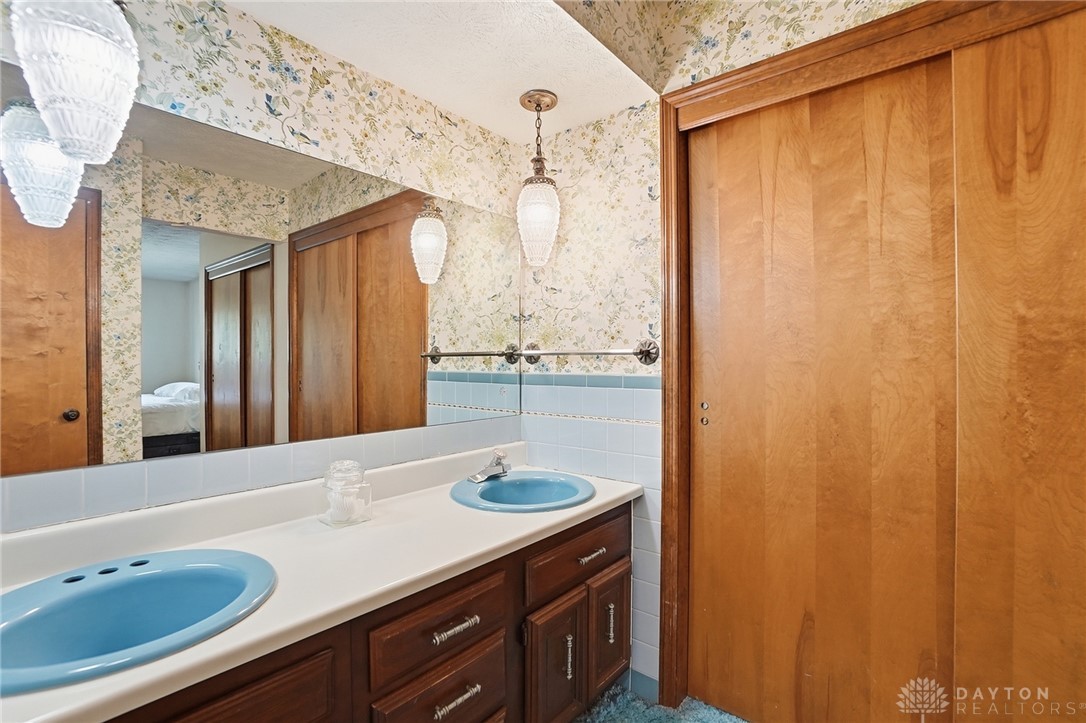 5669 O Neall Road Waynesville, OH 45068 - Photo 35 of 72 This bathroom features a double vanity and unique overhead lighting, offering functional elegance.