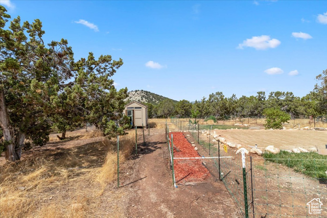 11450 Pigeon Hollow Road Spring City, UT 84662 - Photo 37 of 47 View of yard with a storage unit, a rural view, and a mountain view