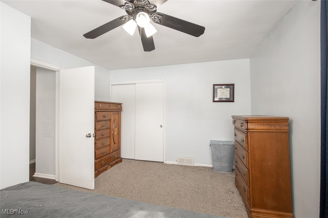 15446 Drake Road Strongsville, OH 44136 - Photo 23 of 42 Unfurnished bedroom with light colored carpet, a ceiling fan, and a closet