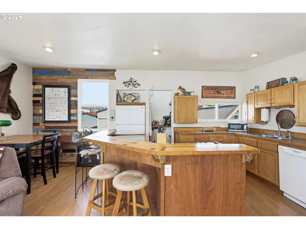 a kitchen with stainless steel appliances granite countertop a sink and a refrigerator