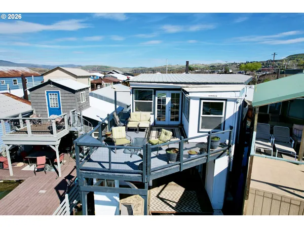 a view of a patio with table and chairs with wooden floor