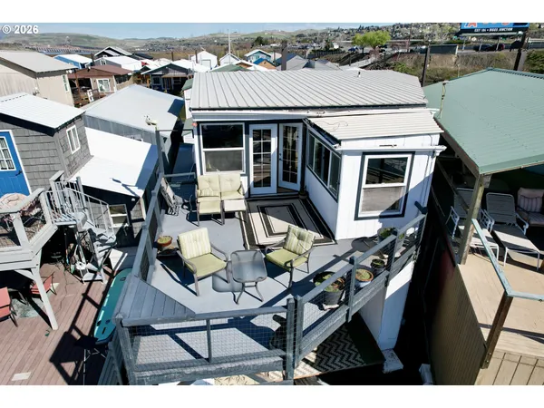 a aerial view of a house with table and chairs