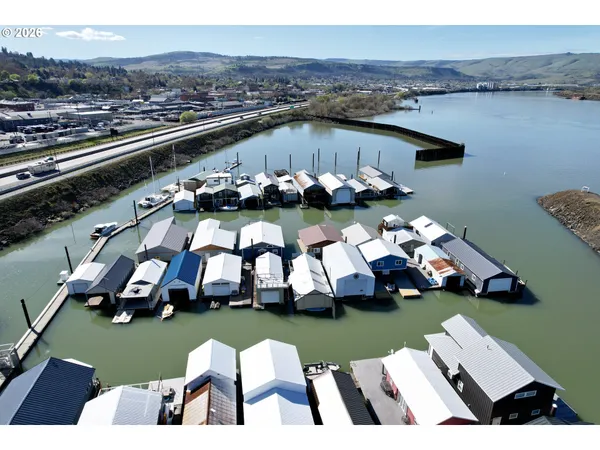 an aerial view of a house with swimming pool garden view and a chairs
