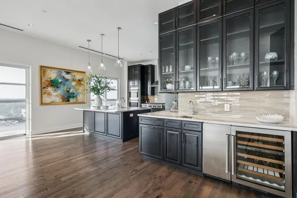 a kitchen with stainless steel appliances granite countertop a stove and cabinets