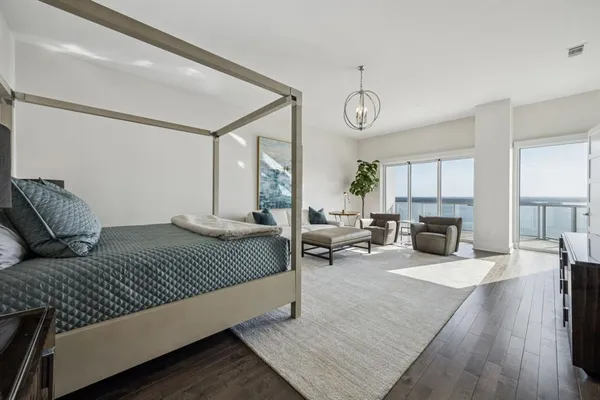 a bedroom with a large bed and a fireplace