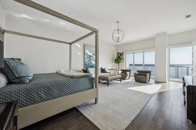 a bedroom with a large bed and a fireplace