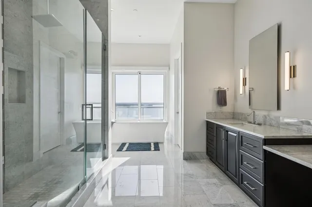 a en suite bathroom with a granite countertop sink and a mirror