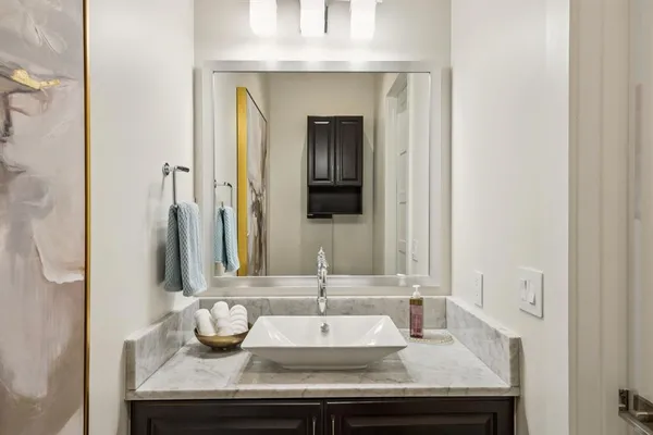 a kitchen with granite countertop white cabinets and stainless steel appliances