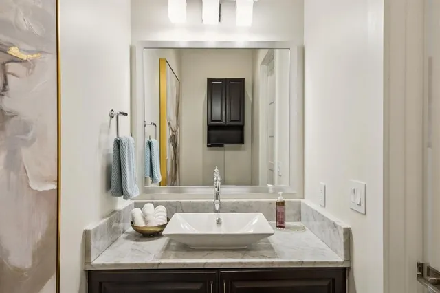 a kitchen with granite countertop white cabinets and stainless steel appliances