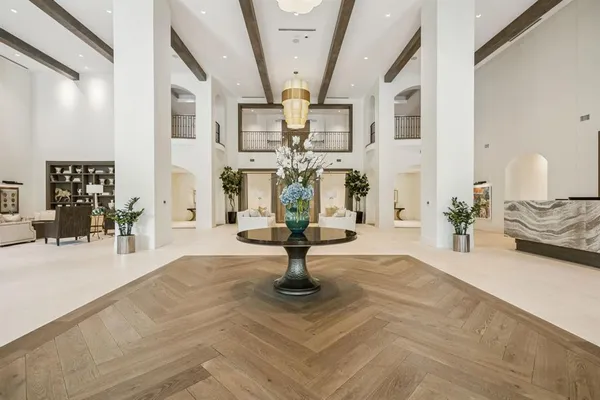 a room with wooden floor table and chairs