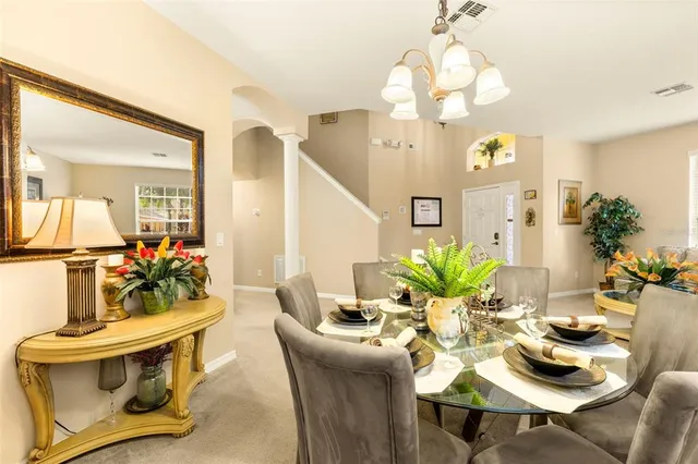 a dining room with a table and chairs