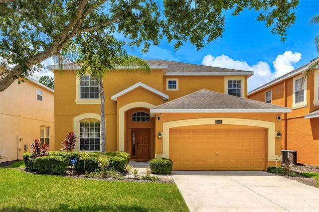 a front view of a house with a yard and garage