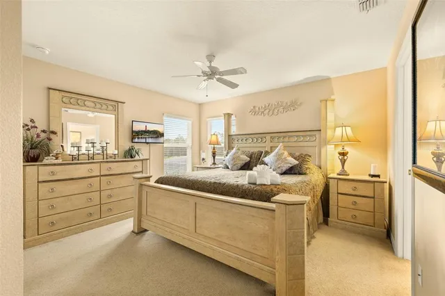 a bedroom with two bed and a painting on the wall