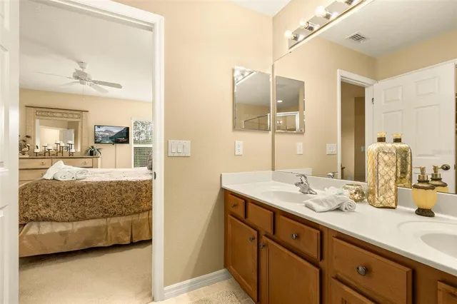 a bedroom with a bed and a mirror on dresser