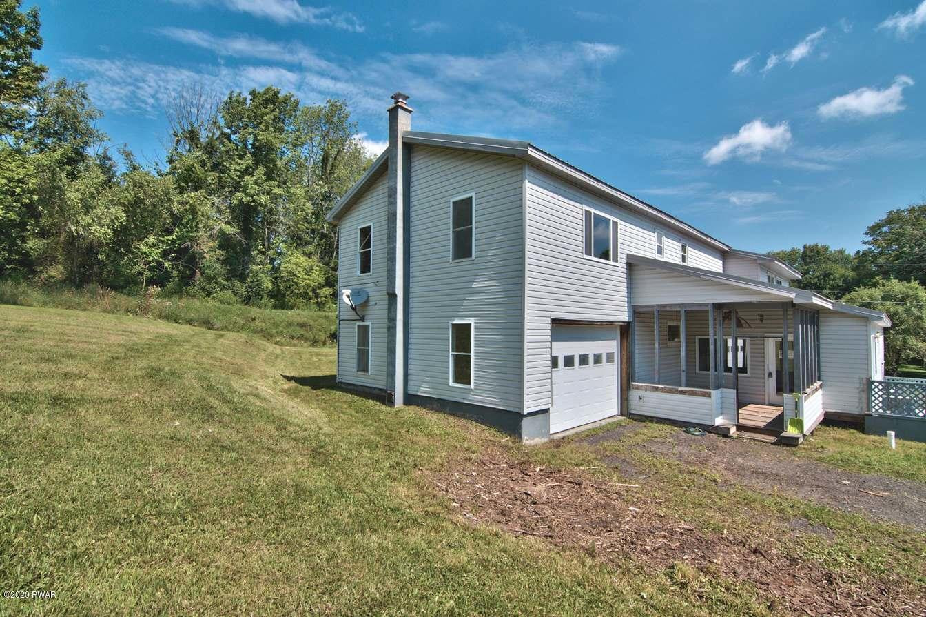 5690 Haas Pond Road Moscow, PA 18444 - Photo 66 of 79 a view of a house with backyard and porch