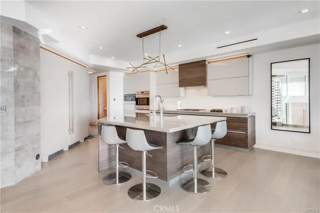 a kitchen with granite countertop cabinets and chairs in it