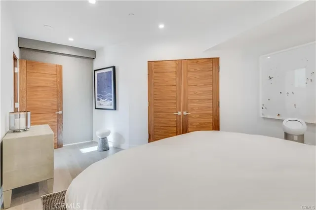 a bedroom with a large bed and a couch