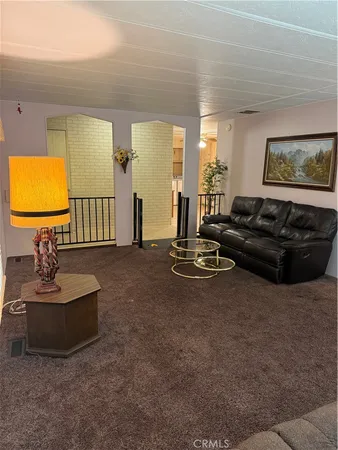 a living room with furniture a window and a flat screen tv