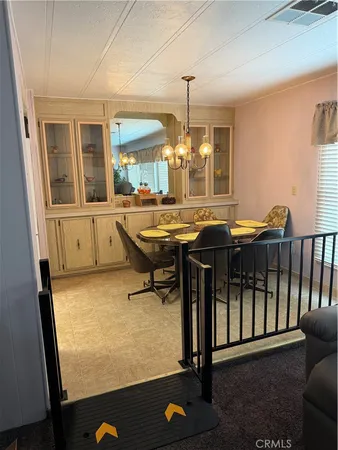 a room with table chairs and wooden floor