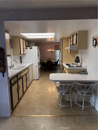 a dining room with furniture and a chandelier