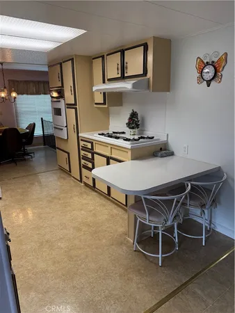 a dining room with furniture and a kitchen view