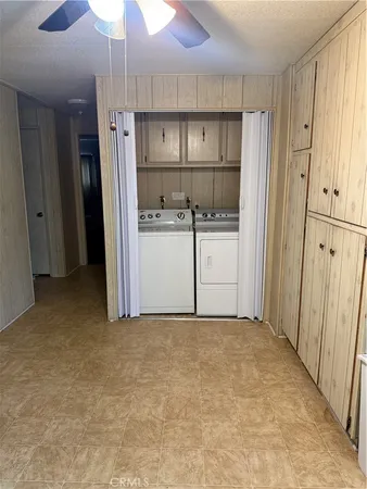 a kitchen with white cabinets and refrigerator