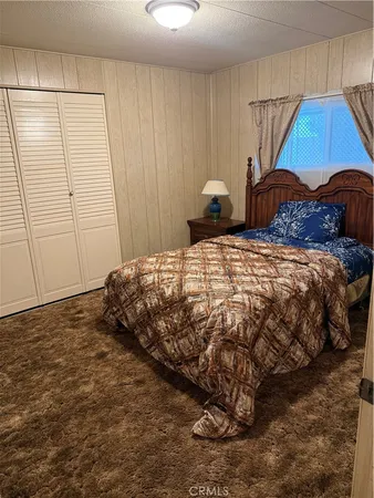 a bedroom with a bed and a room with window