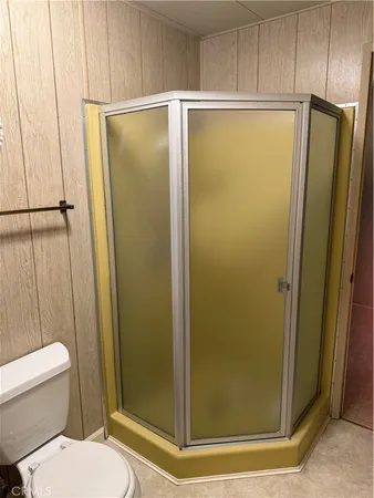 a bathroom with a glass shower door