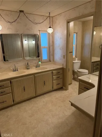 a spacious bathroom with a double vanity sink mirror and double